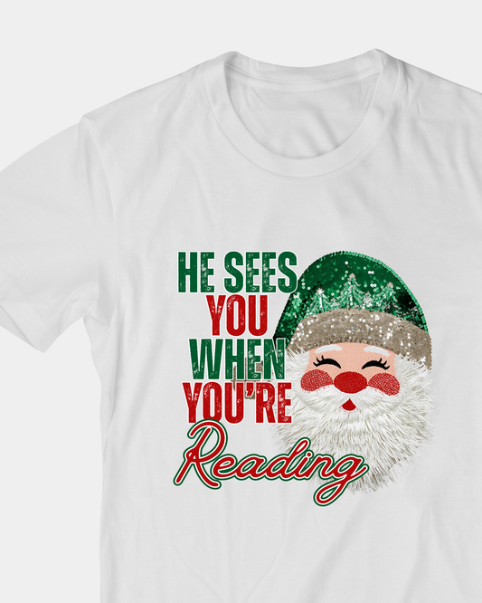 He Sees You When You’re Reading Christmas T-Shirt | Funny Book Lover Holiday Tee | Santa Reading Shirt